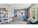 Bright office space with large windows, desk, chair, and stylish decor at 7756 Wheat Stone Dr, Zephyrhills, FL 33540