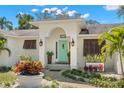 Close-up of the entrance with an eye-catching door, decorative plants, and manicured landscaping at 8236 36Th N Ave, St Petersburg, FL 33710
