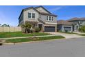 Well-manicured lawn and two-story home with stone accents on a sunny day at 8780 Flourish Dr, Land O Lakes, FL 34637