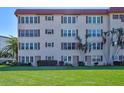 Close exterior view of condo building showing nicely landscaped grounds and numerous windows at 9950 62Nd N Ter # 319, St Petersburg, FL 33708
