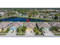 Aerial view of a single-Gathering home featuring a pond, lush landscaping, and a well-maintained neighborhood at 11422 Captiva Kay Dr, Riverview, FL 33569