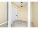 Welcoming front porch featuring a white door with glass pane and overhead lighting fixture at 11422 Captiva Kay Dr, Riverview, FL 33569