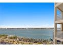 Scenic water view from high-rise condo, showcasing the bay, beach access, and parking areas at 1180 Gulf Blvd # 1604, Clearwater Beach, FL 33767