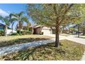 Well-maintained home with a two-car garage, stone accents, and mature trees at 12220 Legacy Bright St, Riverview, FL 33578