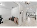 Bright entryway showcasing tile flooring, neutral walls, and open layout leading to the kitchen and bathroom at 12377 Streambed Dr, Riverview, FL 33579