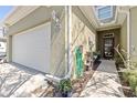 Exterior front view of a garage with address and a front entrance with plants at 12919 Whittington Ct, Largo, FL 33773