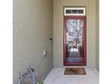 View of the front door with a decorative screen door and welcome mat at 12919 Whittington Ct, Largo, FL 33773