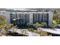 Aerial view showcasing the building exterior and parking with tropical landscape and water views at 1316 Pasadena S Ave # 301, South Pasadena, FL 33707