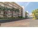 Condominium building boasting multiple stories with balconies and tropical landscaping at 1316 Pasadena S Ave # 301, South Pasadena, FL 33707