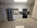 Well-lit kitchen features new appliances, stone countertops, and ample storage at 1400 Gandy N Blvd # 305, St Petersburg, FL 33702