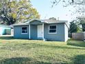 Inviting single-story home with fresh gray paint, white trim, and a well-manicured front lawn at 1409 Franklin St, Clearwater, FL 33756