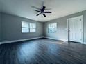 Bright living room features wood-look floors, ceiling fan, freshly painted walls and plenty of natural light at 1409 Franklin St, Clearwater, FL 33756