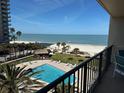 Inviting pool area with palm trees, lounge chairs, and beachfront access for a relaxing vacation at 1480 Gulf Blvd # 401, Clearwater Beach, FL 33767