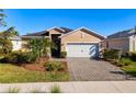 Charming single-story home with well-manicured landscaping, paver driveway, and attached two-car garage at 17533 Timberline Pkwy, Punta Gorda, FL 33982