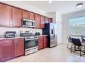 Modern kitchen with stainless steel appliances, granite countertops, and beautiful wood cabinets providing ample storage at 17533 Timberline Pkwy, Punta Gorda, FL 33982