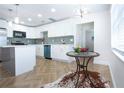 Modern kitchen featuring white cabinets, an island, and stainless steel appliances at 1902 Andover St # 198, Sun City Center, FL 33573