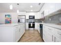 Stylish kitchen featuring stainless steel appliances, white cabinets, and an elegant backsplash at 1902 Andover St # 198, Sun City Center, FL 33573