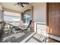 Inviting front porch with a ceiling fan and seating offers a relaxing outdoor space at 2335 E Del Webb Blvd, Sun City Center, FL 33573