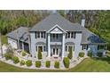 Stately two-story home boasts bay windows, a second story porch and mature landscaping at 27625 Lincoln Pl, Wesley Chapel, FL 33544