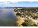 Scenic aerial view of waterfront property and lush green neighborhood at 314 Ontario Ave, Crystal Beach, FL 34681