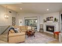 Cozy living room featuring a fireplace, comfortable seating, and natural light at 314 Ontario Ave, Crystal Beach, FL 34681