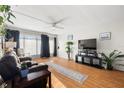 Living room with wood floors, a ceiling fan, and large windows with lots of light at 4152 56Th N Way # 614, Kenneth City, FL 33709