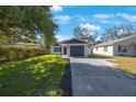 Attractive home featuring a well-kept lawn, driveway, and complementary landscaping at 509 13Th Nw Ave, Largo, FL 33770
