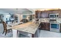 Modern kitchen with granite countertops, stainless steel appliances, and stylish mosaic tile backsplash at 7645 Sun Island S Dr # 201, South Pasadena, FL 33707