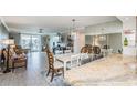Open living and dining area with views of the water and well appointed furnishings at 7645 Sun Island S Dr # 201, South Pasadena, FL 33707