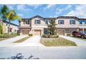 Attractive townhome exteriors with individual driveways and coordinated color schemes at 8512 Reedville St, New Port Richey, FL 34654