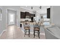 Bright kitchen boasts a breakfast bar, stainless appliances, granite countertops, and pendant lighting at 867 Vino Verde Cir, Brandon, FL 33511