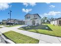 Charming two-story home with a well-manicured lawn, inviting front entrance, and long driveway at 9008 Waxwing Way, Parrish, FL 34219