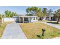 Lovely home with a well-maintained lawn and a convenient circular driveway at 10309 108Th Ave, Largo, FL 33773