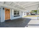 Covered front porch with a stylish front door and decorative window boxes at 10309 108Th Ave, Largo, FL 33773