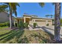 Charming home with a three-car garage, well-maintained landscaping, and mature palms at 10315 Riverdale Rise Dr, Riverview, FL 33578