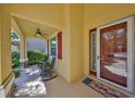 Inviting front porch featuring rocking chairs, ceiling fan, and a storm door at 10315 Riverdale Rise Dr, Riverview, FL 33578