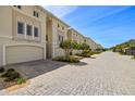 Beautifully landscaped street with elegant condo buildings and brick-paved driveways at 1076 Paseo Del Rio Ne, St Petersburg, FL 33702