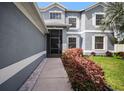 Inviting walkway to a screened front door surrounded by fresh landscaping and a manicured lawn at 11310 Callaway Pond Dr, Riverview, FL 33579