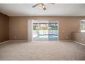 Bright main bedroom features sliding glass doors that offer serene views of the pool at 11310 Callaway Pond Dr, Riverview, FL 33579