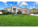 Gorgeous home with a lush green lawn, paver driveway, and a convenient three-car garage at 15909 39Th E Gln, Parrish, FL 34219