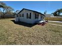 A well-maintained home features a freshly painted exterior and a spacious lawn at 1913 Park Ave, Tarpon Springs, FL 34689