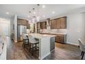 Modern kitchen featuring a center island with seating, stainless steel appliances, and pendant lighting at 19445 Redwood Point Dr, Tampa, FL 33647