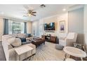 Comfortable living room with a large sectional sofa, stylish decor, and access to the screened-in patio at 19445 Redwood Point Dr, Tampa, FL 33647