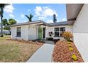 Close-up of the home's front door with nice landscaping and walkway leading to it at 2008 41St W St, Bradenton, FL 34205
