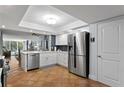Modern kitchen features stainless steel appliances, white cabinets, and a convenient breakfast bar at 201 W Laurel St # 212, Tampa, FL 33602