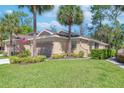 Well-maintained home features lush green lawn and mature landscaping, enhancing its curb appeal and charm at 2206 Preservation Dr # 2206, Plant City, FL 33566