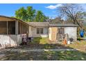 View of a backyard with sheds, utility boxes, and outdoor equipment at 22295 Powell Rd, Brooksville, FL 34602