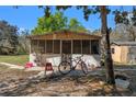 View of a screen patio and a house in the backyard at 22295 Powell Rd, Brooksville, FL 34602