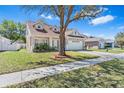 Charming single-Gathering home featuring a well-maintained lawn and two-car garage on a peaceful street at 24648 Siena Dr, Lutz, FL 33559