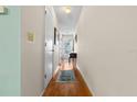 Clean, bright hallway with wood flooring, neutral walls, and streamlined access to rooms at 330 Brandy Wine Dr # 330, Largo, FL 33771